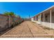 Backyard featuring gravel landscaping, cinder block walls, and enclosed patio at 544 S Crismon Rd, Mesa, AZ 85208