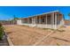 Backyard featuring gravel landscaping, cinder block walls, and enclosed patio at 544 S Crismon Rd, Mesa, AZ 85208