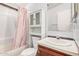 Bright bathroom with cherry vanity, medicine cabinet, and shower with curtain at 544 S Crismon Rd, Mesa, AZ 85208