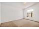 White bedroom featuring carpeted floors, white walls, and a sunlit window at 544 S Crismon Rd, Mesa, AZ 85208
