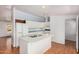 Bright kitchen features an island, white cabinets, and laminate floors at 544 S Crismon Rd, Mesa, AZ 85208