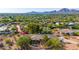 Stunning aerial view of the beautiful home with mountain views, lush trees, and mature desert landscaping at 5744 E Oak St, Scottsdale, AZ 85257