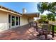 A well-maintained deck with outdoor seating featuring a lush landscaped backyard with mature trees at 5744 E Oak St, Scottsdale, AZ 85257