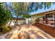 A well-maintained yard featuring a patio with desert landscaping, lush greenery, and mature trees at 5744 E Oak St, Scottsdale, AZ 85257