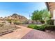 Scenic backyard with a mountain view, featuring a brick patio and manicured landscaping, complemented by an American flag at 5744 E Oak St, Scottsdale, AZ 85257