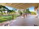 A well-maintained wooden deck overlooking the meticulously manicured backyard with a lawn at 5744 E Oak St, Scottsdale, AZ 85257