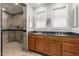 Bathroom featuring double sinks, granite countertops, and a tiled walk-in shower at 5744 E Oak St, Scottsdale, AZ 85257