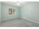 Bright bedroom with neutral carpet, and a window providing natural light at 5744 E Oak St, Scottsdale, AZ 85257