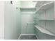 Walk-in closet featuring white shelves for optimized storage and organization at 5744 E Oak St, Scottsdale, AZ 85257