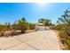 Charming home with a long driveway surrounded by desert landscape and clear blue skies at 5744 E Oak St, Scottsdale, AZ 85257