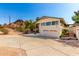 Charming two-story home featuring a two-car garage, and desert landscaping on a sunny day at 5744 E Oak St, Scottsdale, AZ 85257