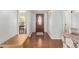 Elegant foyer with hardwood floors, a decorative front door, and a view of the dining room, creating a warm entrance at 5744 E Oak St, Scottsdale, AZ 85257
