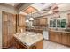 Charming kitchen with granite countertops, tiled backsplash, and a center island with a stovetop at 5744 E Oak St, Scottsdale, AZ 85257