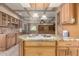 Charming kitchen with granite countertops, wood cabinets, and center island with stovetop and seating at 5744 E Oak St, Scottsdale, AZ 85257
