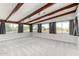 Sunlit living room showcasing exposed beams, neutral colors, and multiple windows at 5744 E Oak St, Scottsdale, AZ 85257