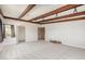 Spacious living room with exposed beams, plush carpeting, and many windows at 5744 E Oak St, Scottsdale, AZ 85257