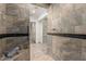 Tiled walk-in shower featuring a tiled bench seat and a glass partition at 5744 E Oak St, Scottsdale, AZ 85257