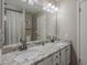 Bathroom with a double sink vanity, granite countertops, and a shower-tub combination at 5911 E Evergreen St, Mesa, AZ 85205