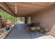 Inviting covered patio featuring concrete floors and a comfortable seating area, ideal for relaxing or entertaining at 5911 E Evergreen St, Mesa, AZ 85205