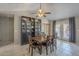 Bright dining area with a vaulted ceiling, a wooden table with chairs, and tile flooring at 5911 E Evergreen St, Mesa, AZ 85205