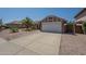 Charming single-story home featuring a driveway, desert landscaping and a two-car garage at 5911 E Evergreen St, Mesa, AZ 85205