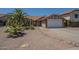 Charming single-story home with desert landscaping and a spacious two-car garage and a red tile roof at 5911 E Evergreen St, Mesa, AZ 85205