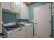 Laundry room featuring a modern washer and dryer with white cabinets at 5911 E Evergreen St, Mesa, AZ 85205