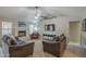 Inviting living room featuring plush sofas, a brick fireplace and a large television for entertainment at 5911 E Evergreen St, Mesa, AZ 85205