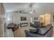 Cozy living room with a ceiling fan, carpet floors, a TV, and a brick fireplace at 5911 E Evergreen St, Mesa, AZ 85205