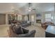 Open-concept living room and dining area, featuring tile floors, a fireplace, and a dining table with chairs at 5911 E Evergreen St, Mesa, AZ 85205