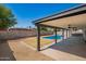 Expansive backyard featuring a sparkling pool and covered patio area for relaxation at 6140 W Berkeley Rd, Phoenix, AZ 85035