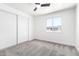 Bright bedroom featuring a ceiling fan, a window, a closet, and plush carpet at 6140 W Berkeley Rd, Phoenix, AZ 85035