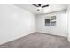Neutral bedroom with a ceiling fan, a window, and plush carpet at 6140 W Berkeley Rd, Phoenix, AZ 85035