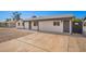 Long driveway leading to the house with ample parking space and rock landscaping at 6140 W Berkeley Rd, Phoenix, AZ 85035