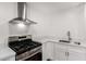 Kitchen featuring white cabinets, stainless steel appliances, and stone countertops at 6140 W Berkeley Rd, Phoenix, AZ 85035