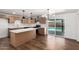 Modern kitchen with stainless steel appliances, granite countertops, and sliding doors to the backyard at 6140 W Berkeley Rd, Phoenix, AZ 85035