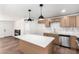 Bright kitchen boasts shaker cabinets, modern stainless appliances, light countertops, and a spacious center island at 6140 W Berkeley Rd, Phoenix, AZ 85035