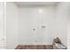 Bright laundry room with hardwood-style flooring and utility connections at 6140 W Berkeley Rd, Phoenix, AZ 85035
