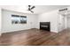 Spacious living room with modern fireplace, laminate flooring and abundant natural light at 6140 W Berkeley Rd, Phoenix, AZ 85035