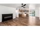 Open-concept living area with modern fireplace flowing into the kitchen with an island at 6140 W Berkeley Rd, Phoenix, AZ 85035