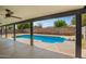 Covered patio with a view of the refreshing backyard swimming pool at 6140 W Berkeley Rd, Phoenix, AZ 85035