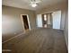 Spacious bedroom featuring neutral walls, carpet flooring, and an open entry into the bathroom at 6460 S Springs Pl, Chandler, AZ 85249