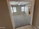 Neutral-toned bedroom with carpet flooring, windows, and a ceiling fan for added comfort at 6460 S Springs Pl, Chandler, AZ 85249