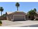 Charming single-story home featuring a two-car garage and desert landscaping with palm trees at 6460 S Springs Pl, Chandler, AZ 85249
