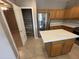Well-equipped kitchen with stainless steel appliances, a spacious pantry, and an island at 6460 S Springs Pl, Chandler, AZ 85249