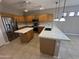 Spacious kitchen with light wood cabinets, stainless steel appliances, and a large center island at 6460 S Springs Pl, Chandler, AZ 85249