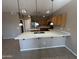 Modern kitchen boasts stainless steel appliances, wood cabinetry and a large center island for dining at 6460 S Springs Pl, Chandler, AZ 85249