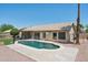 Back exterior view of home with a sparkling private pool and mature palm trees in the backyard at 6645 E Preston St, Mesa, AZ 85215