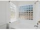 Bright bathroom features glass block windows and a soaking tub with updated showerhead at 6645 E Preston St, Mesa, AZ 85215