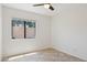 Bright bedroom features tile flooring, a ceiling fan, and a window at 6645 E Preston St, Mesa, AZ 85215
